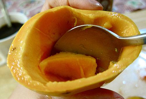 Extragerea pulpei de mango cu o lingură